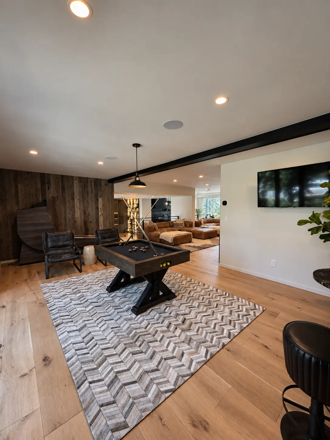 Game room with reclaimed wood feature wall and integrated wine storage