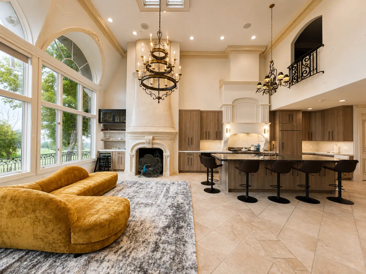 Completed kitchen and hearth room with carved cast-stone fireplace and travertine flooring
