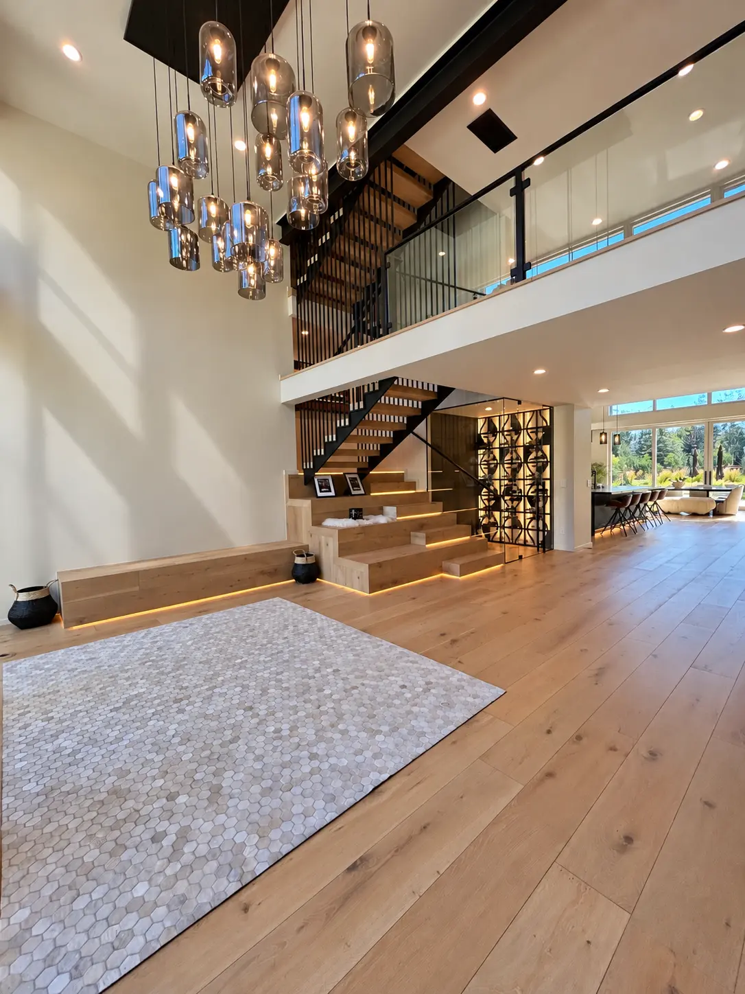 Double-height interior with custom staircase and sculptural chandelier