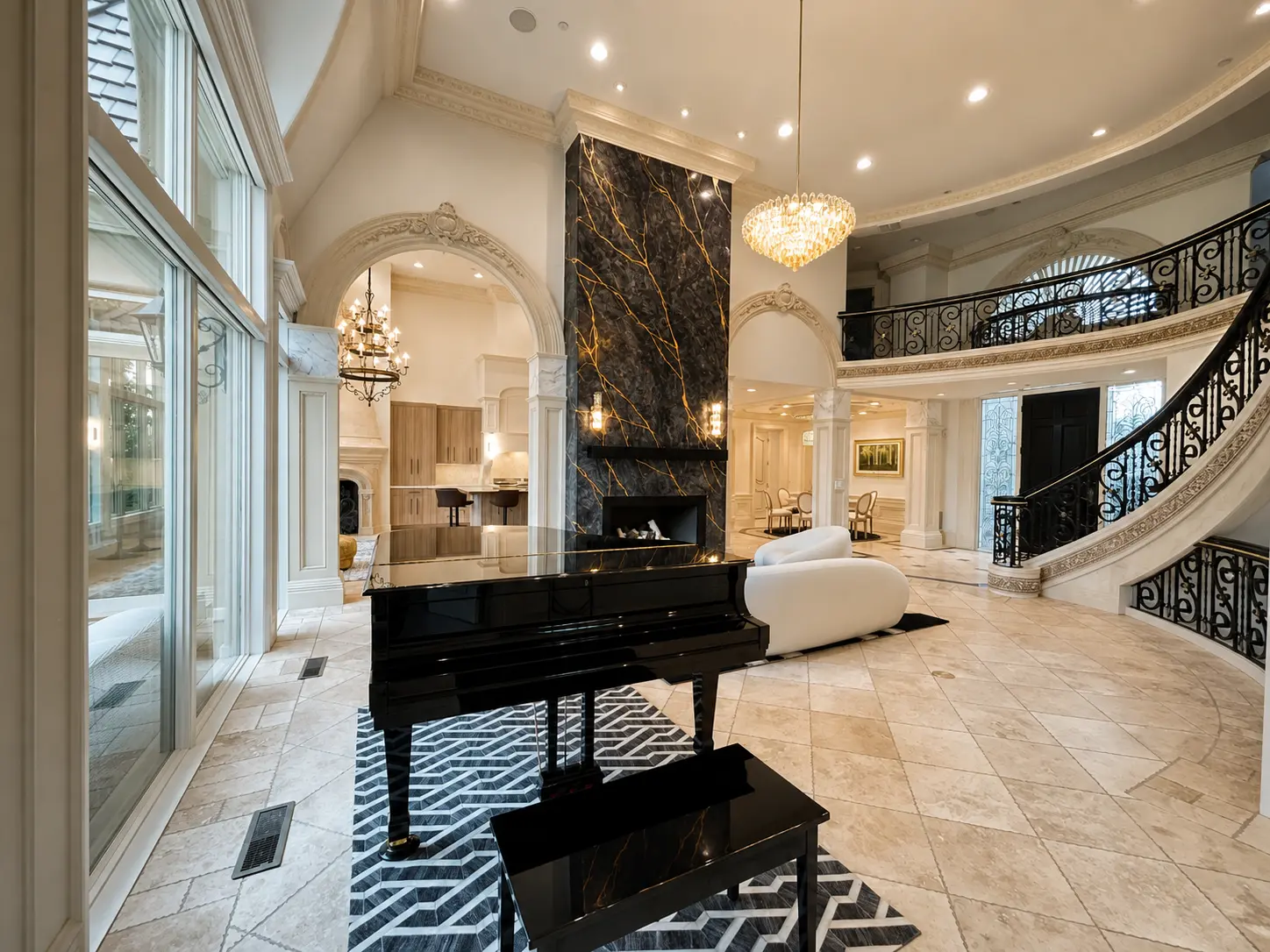 Completed main living room with floor-to-ceiling stone fireplace, grand piano, and curved staircase