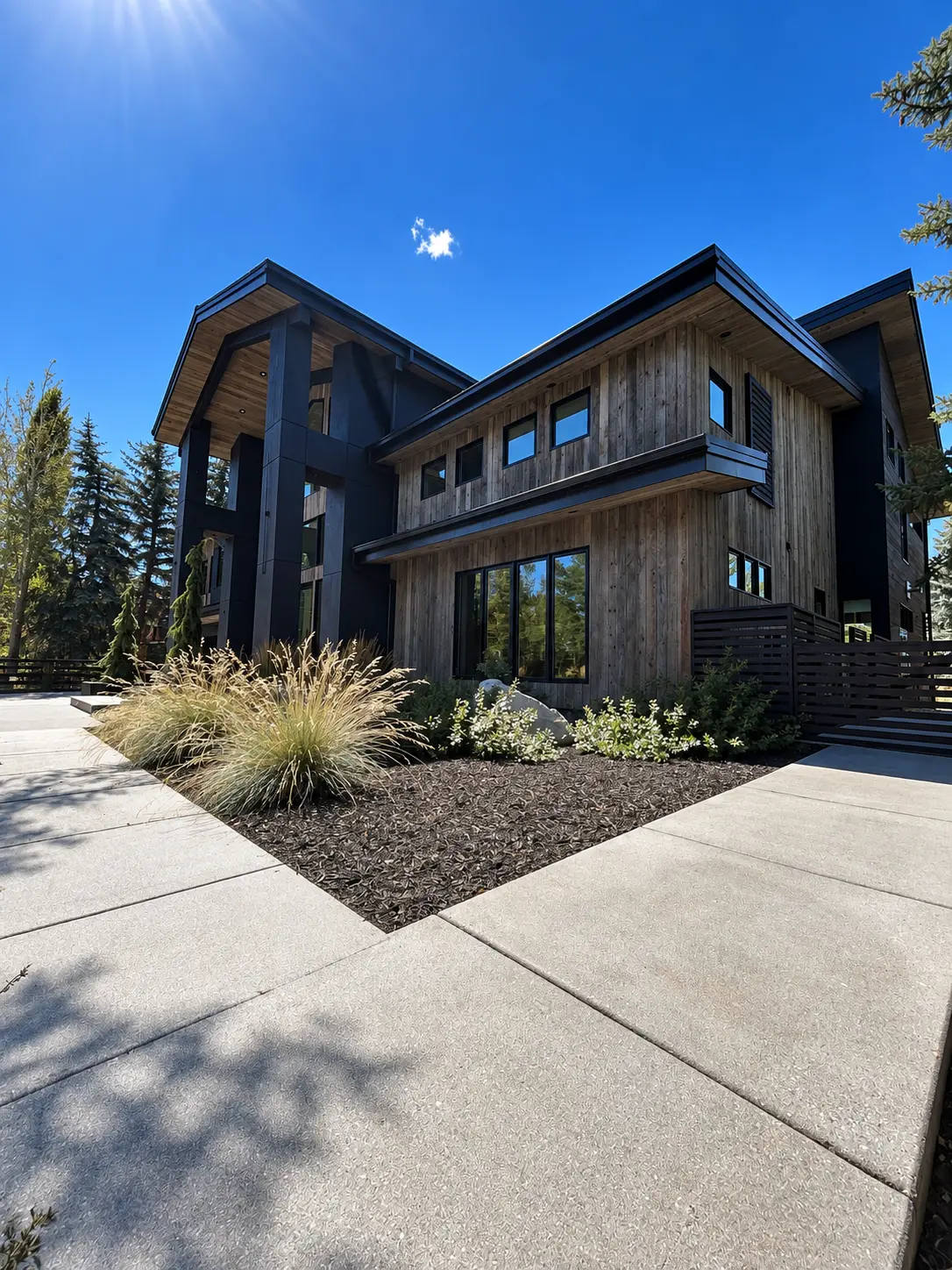 Lucky John Residence front elevation with weathered timber siding and landscaped entrance